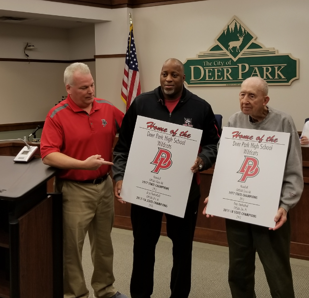Hank Estes and Steve Gentry holding signs given by Mayor Donnellon 